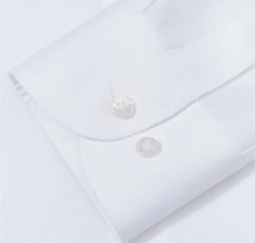 Close-up of a white shirt with buttons on a light gray background